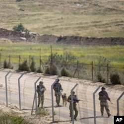 Israeli troops patrol along the border between Israel and Syria near the village of Majdal Shams in the Golan Heights, June 6, 2011