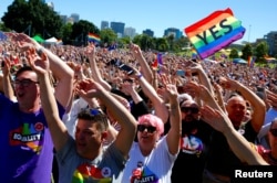 FILE - Supporters of the "Yes" vote for marriage equality celebrate after it was announced the majority of Australians support same-sex marriage in a national survey.
