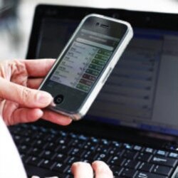 An amateur trader, Yan Qin, checks her smartphone for stock reports in New York on December 7