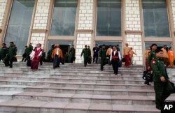 FILE - Lawmakers of the National League for Democracy party (NLD) and Military representatives leave the parliament after attending a regular session of the Union Parliament, Aug. 25, 2016, in Naypyitaw, Myanmar.