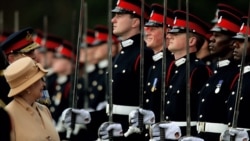 FILE - Britain's Queen Elizabeth smiles with Prince Harry during the Sovereign's Parade at the Royal Military Academy in Sandhurst, southern England April 12, 2006.
