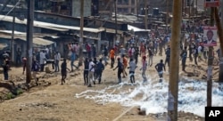 Opposition supporters throwing stones flee as police fire tear gas during clashes in the Kawangware area of Nairobi, Kenya, Oct. 28, 2017. Clashes between supporters of opposition leader Raila Odinga and police continued in Kawangware, and it was still not clear when the presidential election, a rerun of the flawed vote in August, would be over.