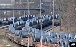 FILE - Steel coils sit on wagons when leaving the thyssenkrupp steel factory in Duisburg, Germany, March 2, 2018.