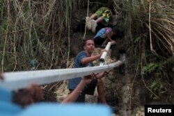People collect mountain spring water, after Hurricane Maria hit the island, in Corozal, Puerto Rico, Oct. 17, 2017.