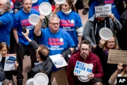 Furloughed government workers affected by the shutdown hold a silent protest against the ongoing partial government shutdown on Capitol Hill in Washington, Jan. 23, 2019.