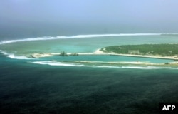 FILE - This file aerial view taken on July 27, 2012 shows part of the city of Sansha on the island of Yongxing, also known as Woody island in the disputed Paracel chain, which China now considers part of Hainan province.