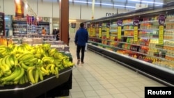 FILE - A man shops in a mall in Doha, Qatar, June 8, 2017. Sanctions imposed by Saudi Arabia and other Arab states have allowed Qatar businesses to make deals with Turkish, Indian and Chinese companies.