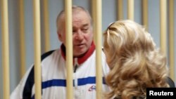 FILE - Sergei Skripal, a former colonel of Russia's GRU military intelligence service, looks on from the defendants' cage at a hearing at the Moscow military district court, Russia, Aug. 9, 2006.