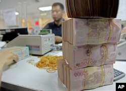 រូបឯកសារ៖ ប្រាក់​ដុង​របស់​វៀតណាម នៅ​ធនាគារ​ពាណិជ្ជកម្ម​អាស៊ី ក្នុង​ទីក្រុង​ហាណូយ​ប្រទេស​វៀតណាម។