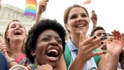 People celebrate outside the Supreme Court after its historic decision on gay marriage, in Washington, D.C., June 26, 2015.
