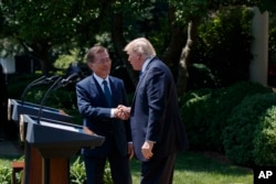 South Korean President Moon Jae-in shakes hands with President Donald Trump, right, after making statements in the Rose Garden of the White House in Washington, June 30, 2017.