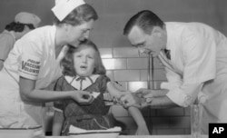 In 1954 this child in Virginia is vaccinated with the new Salk polio vaccine. Today, only 3 countries in the world have never stopped spread of polio. They are Pakistan, Afghanistan and Nigeria.(AP File Photo)