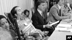 Edward Roberts with Gov. Edmund G. Brown after he signed AB 204, a bill to continue 18 centers for independent living.