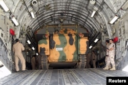 FILE - Turkish troops seen unloading a vehicle at their military base in Doha, Qatar, June 23, 2017.