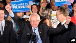 Democratic presidential candidate, Sen. Bernie Sanders, I-Vt., reacts to the cheering crowd at his primary night rally in Manchester, New Hampshire, Feb. 9, 2016.