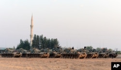Turkish tanks stationed near the Syrian border, in Karkamis, Turkey, Aug. 27, 2016.