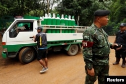 A truck carrying oxygen tanks arrives outside the Tham Luang cave complex, July 8, 2018.