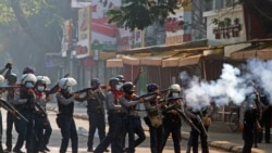 Riot police officers fire teargas canisters during a protest against the military coup in Yangon, Myanmar, February 28, 2021. REUTERS/Stringer NO RESALES NO ARCHIVE