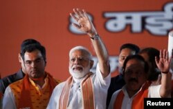 India's Prime Minister Narendra Modi waves toward his supporters during an election campaign rally in New Delhi, May 8, 2019.