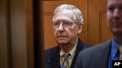 Senate Majority Leader Mitch McConnell, R-Ky., arrives at the Capitol in Washington, Jan. 19, 2018, as a bitterly-divided Congress hurtles toward a government shutdown this weekend.