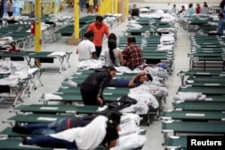 FILE - Migrants from Central America rest inside the "House of the Refugee," which gives temporary shelter to migrants released by ICE and CBP because of overcrowded facilities, in El Paso, Texas, April 24, 2019.