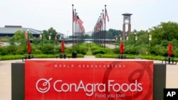 FILE - Flags fly over ConAgra Foods world headquarters in Omaha, Nebraska, June 30, 2015. ConAgra Foods moved 1,000 jobs in 2016 from Omaha to Chicago.