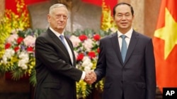 FILE - U.S. Secretary of Defense Jim Mattis, left, shakes hands with Vietnamese President Tran Dai Quang before holding talks in Hanoi, Vietnam, Jan. 25, 2018.