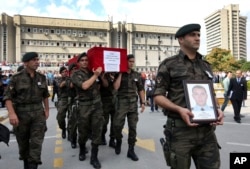 FILE - Turkish police officers carry the coffin of Turkish police special operations officer Sahin Polat Aydin, one of the four officers killed in a landmine attack attributed to PKK militants.