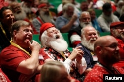 Santas laugh as they learn about Santa Spirit during class at the Charles W. Howard Santa Claus School in Midland, Michigan, Oct. 27, 2016.