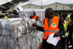 Independent Electoral and Boundaries Commission IEBC officials receive ballot papers for the repeat of the presidential election on Oct. 26, at JKIA airport in Nairobi, Kenya, Oct. 23, 2017.