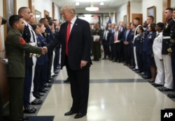 President Donald Trump greets military personnel during his visit to the Pentagon, July 20, 2017.
