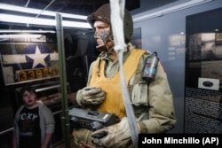 In this Friday, April 26, 2019 photo, visitors browse the D-Day displays at the The National Museum of the U.S. Air Force, in Dayton, Ohio.