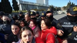 Police officers push back protesters during a rally of journalists against a new media bill, in front of the Parliament building in Baku, Azerbaijan, on Dec. 28, 2021.