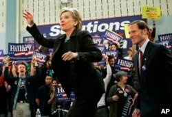 FILE - Then-Democratic presidential hopeful, Sen. Hillary Rodham Clinton, D-N.Y., waves while taking the stage with then-Connecticut Atty. Gen. Richard Blumenthal during a rally in Hartford, Connecticut, Jan. 28, 2008.