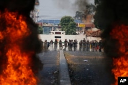 National Guard troops man a barricade blocking access to the Francisco De Paula Santander international bridge in Urena, Venezuela, on the border with Colombia, Feb. 23, 2019.