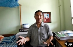 FILE - Kyaw Win, then a lawmaker of National League for Democracy party, speaks to journalists in Naypyitaw, Myanmar, March 22, 2016.