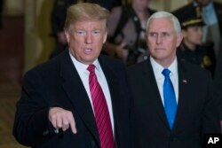 President Donald Trump, accompanied by Vice President Mike Pence, speaks as he arrives for a Senate Republican policy luncheon, on Capitol Hill in Washington, Jan. 9, 2019.