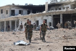 Forces loyal to Syria's President Bashar al-Assad walk at a military complex after they recaptured areas in southwestern Aleppo on Sunday that rebels had seized last month, Syria, in this handout picture provided by SANA on Sep. 5, 2016.