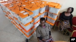 FILE - Polling station workers are seen guarding ballot boxes following presidential elections in Lusaka, Zambia, Jan. 21, 2015. Lungu prevailed at that poll, which was called to replace Zambia's late president Michael Sata.