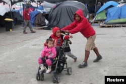 FILE - Migrant children from Nicaragua, part of a caravan of thousands from Central America tying to reach the United States, play at a temporary shelter in Tijuana, Mexico, Jan. 18, 2019.