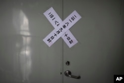 FILE - Government seals are seen on a rear entrance of the Zion church after it was shut down by authorities in Beijing, China, Sept. 11, 2018.