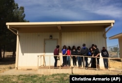 In this April 30, 2015 photo, students line up outside classroom at the Cuyama Valley High School in New Cuyama, California. The school is 60 miles from the nearest city