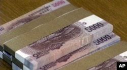FILE - This image made from Associated Press Television News video shows North Korean bank notes in Pyongyang, North Korea, Feb. 2, 2015.