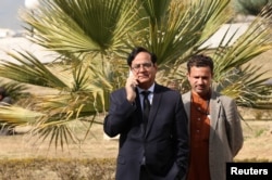 Saiful Mulook (L), lawyer for Asia Bibi, a Pakistani Christian acquitted of capital blasphemy charges, talks on a mobile phone at the premises of the Supreme Court in Islamabad, Jan. 29, 2019.