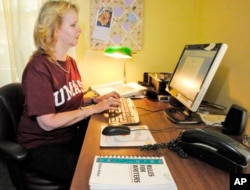 FILE -- Laurel Ranticelli looks at her University of Massachusetts online class information at her home in Springfield, Mass.