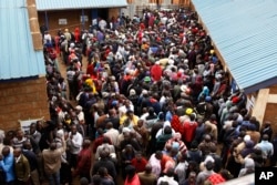 FILE - Voters line up early morning at a polling station in the Kibera Slums in Nairobi, Kenya, Aug. 8, 2017.