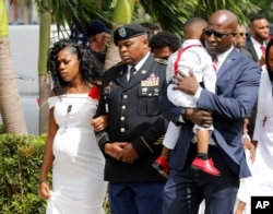 Myeshia Johnson, widow of U.S. Army Sergeant La David Johnson, who was among four special forces soldiers killed in Niger, is escorted into his graveside service in Hollywood, Florida, Oct. 21, 2017.
