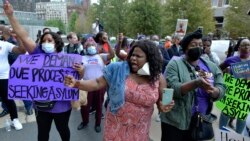 Haitian-Americans chant during a demonstration at the JFK Federal Building in Boston, Sept. 24, 2021.