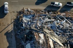 In this aerial photo, a collapsed candle factory is seen with workers searching for survivors, after tornadoes came through the area the previous night, in Mayfield, Kentucky, Dec. 12, 2021.