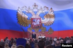 Russian President Vladimir Putin addresses Russian lawmakers, regional governors and other high-ranking officials, in Moscow, Russia, March 1, 2018.